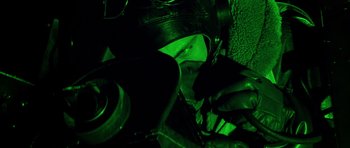 Movie still from “La Grande Vadrouille” (1966), directed by Gérard Oury – A person wearing a helmet and gloves in a dark room; Close Up shot, Overhead angle