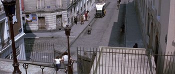 Movie still from “La Grande Vadrouille” (1966), directed by Gérard Oury – People walking down a street with a bus on the sidewalk; Extreme Wide shot, High angle