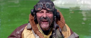 Movie still from “La Grande Vadrouille” (1966), directed by Gérard Oury – An older man wearing a pilot's jacket and goggles; Close Up shot, Low angle