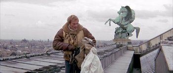 Movie still from “La Grande Vadrouille” (1966), directed by Gérard Oury – A man and a woman standing on a roof top; Medium shot, Low angle