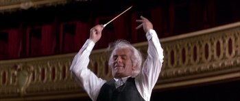 Movie still from “La Grande Vadrouille” (1966), directed by Gérard Oury – An older man is holding a conductor's baton; Close Up shot, Low angle