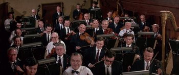 Movie still from “La Grande Vadrouille” (1966), directed by Gérard Oury – A group of men in suits and ties playing musical instruments; Wide shot, High angle