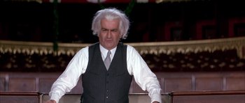 Movie still from “La Grande Vadrouille” (1966), directed by Gérard Oury – An older man in a vest and a tie; Medium shot, Over the shoulder angle