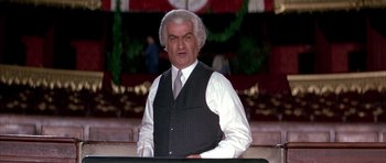 Movie still from “La Grande Vadrouille” (1966), directed by Gérard Oury – An older man wearing a vest and a tie; Medium shot, High angle