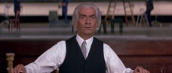 Movie still from “La Grande Vadrouille” (1966), directed by Gérard Oury – An older man in a vest and tie; Close Up shot, Low angle