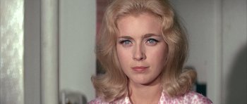 Movie still from “La Grande Vadrouille” (1966), directed by Gérard Oury – A person with long blonde hair; Close Up shot, Over the shoulder angle