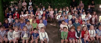 Movie still from “La Grande Vadrouille” (1966), directed by Gérard Oury – A large group of children sitting in front of a woman; Wide shot, High angle