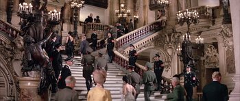 Movie still from “La Grande Vadrouille” (1966), directed by Gérard Oury – A group of people standing on top of a set of stairs; Wide shot, High angle