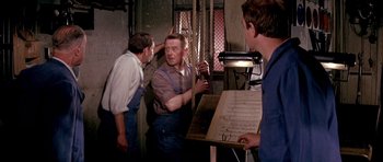 Movie still from “La Grande Vadrouille” (1966), directed by Gérard Oury – A group of men standing next to each other in a room; Medium shot, Low angle