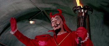 Movie still from “La Grande Vadrouille” (1966), directed by Gérard Oury – A man dressed as a devil in a red costume; Medium shot, Low angle
