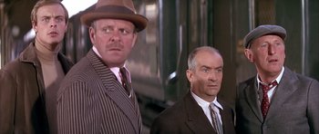 Movie still from “La Grande Vadrouille” (1966), directed by Gérard Oury – A man in a suit and a man in a hat; Medium shot, Low angle