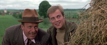 Movie still from “La Grande Vadrouille” (1966), directed by Gérard Oury – A man and a man with a hat on; Close Up shot, Low angle