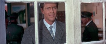 Movie still from “La Grande Vadrouille” (1966), directed by Gérard Oury – A person wearing a suit and tie; Close Up shot, Low angle