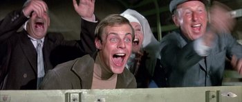 Movie still from “La Grande Vadrouille” (1966), directed by Gérard Oury – A man and a woman are laughing and making funny faces; Close Up shot, Low angle