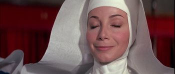 Movie still from “La Grande Vadrouille” (1966), directed by Gérard Oury – A woman wearing a nun's hat and a white robe; Close Up shot, High angle