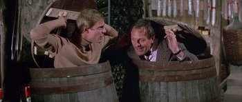 Movie still from “La Grande Vadrouille” (1966), directed by Gérard Oury – Two men sitting next to each other in wooden barrels; Medium shot, Over the shoulder angle
