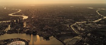 Movie still from “Doomsday” (2008), directed by Neil Marshall – An aerial view of a large city at sunset; Extreme Wide shot, High angle