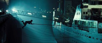 Movie still from “Doomsday” (2008), directed by Neil Marshall – A person on a rope in a dark room at night; Extreme Wide shot, Low angle
