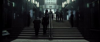 Movie still from “Doomsday” (2008), directed by Neil Marshall – A group of people walking up and down some stairs; Wide shot, Low angle