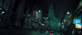 Movie still from “Doomsday” (2008), directed by Neil Marshall – A street scene with a car driving down the street; Extreme Wide shot, High angle