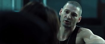 Movie still from “Doomsday” (2008), directed by Neil Marshall – A person with a beard; Close Up shot, Over the shoulder angle