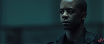 Movie still from “Doomsday” (2008), directed by Neil Marshall – A person wearing a police uniform; Close Up shot, Low angle