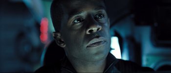 Movie still from “Doomsday” (2008), directed by Neil Marshall – A man's face in the dark; Close Up shot, Low angle