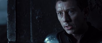 Movie still from “Doomsday” (2008), directed by Neil Marshall – A person wearing a helmet; Close Up shot, Over the shoulder angle