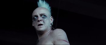 Movie still from “Doomsday” (2008), directed by Neil Marshall – A person with a mohawk; Close Up shot, Low angle