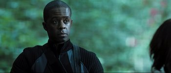 Movie still from “Doomsday” (2008), directed by Neil Marshall – A person wearing a black shirt; Close Up shot, Low angle