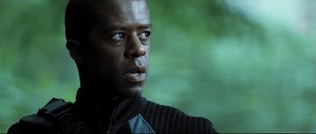 Movie still from “Doomsday” (2008), directed by Neil Marshall – A person wearing a black jacket; Close Up shot, Low angle