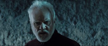 Movie still from “Doomsday” (2008), directed by Neil Marshall – An old man with white hair and a white beard looking angry; Close Up shot, Low angle