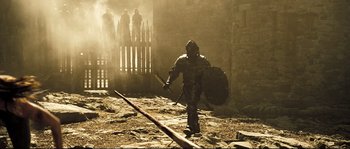 Movie still from “Doomsday” (2008), directed by Neil Marshall – A man with a sword and a shield; Wide shot, Low angle