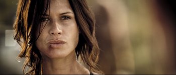 Movie still from “Doomsday” (2008), directed by Neil Marshall – A woman's face with long brown hair; Close Up shot, Low angle