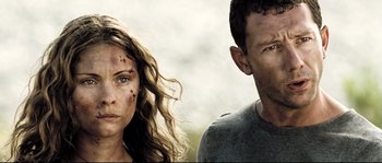 Movie still from “Doomsday” (2008), directed by Neil Marshall – A man and a woman standing next to each other; Close Up shot, Low angle