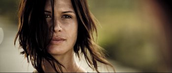 Movie still from “Doomsday” (2008), directed by Neil Marshall – A woman's face with long brown hair; Close Up shot, Low angle