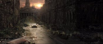Movie still from “Doomsday” (2008), directed by Neil Marshall – An abandoned street with a car parked on the side of the road; Extreme Wide shot, High angle