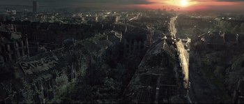 Movie still from “Doomsday” (2008), directed by Neil Marshall – An aerial view of a city at sunset; Extreme Wide shot, High angle