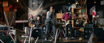 Movie still from “Dope” (2015), directed by Rick Famuyiwa – A group of young men playing musical instruments in a room; Wide shot, Low angle