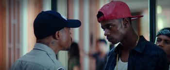 Movie still from “Dope” (2015), directed by Rick Famuyiwa – A man in a red hat and a man in a black shirt; Close Up shot, Over the shoulder angle