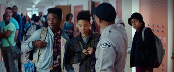 Movie still from “Dope” (2015), directed by Rick Famuyiwa – A group of young men standing next to each other; Medium shot, Over the shoulder angle