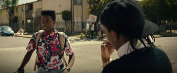 Movie still from “Dope” (2015), directed by Rick Famuyiwa – Two people sitting on the side of the road talking; Medium shot, Over the shoulder angle