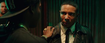 Movie still from “Dope” (2015), directed by Rick Famuyiwa – A man in a leather jacket is looking at his reflection in a mirror; Close Up shot, Over the shoulder angle