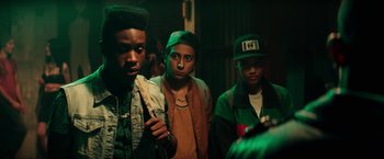 Movie still from “Dope” (2015), directed by Rick Famuyiwa – A group of young men standing next to each other in a room; Close Up shot, Over the shoulder angle