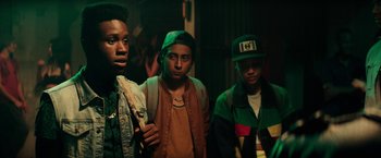 Movie still from “Dope” (2015), directed by Rick Famuyiwa – A group of young men standing next to each other in a room; Close Up shot, Over the shoulder angle