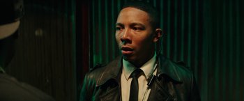 Movie still from “Dope” (2015), directed by Rick Famuyiwa – A man wearing a leather jacket and a tie; Close Up shot, Over the shoulder angle