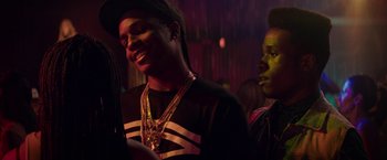 Movie still from “Dope” (2015), directed by Rick Famuyiwa – A man in a black and white shirt and a woman in a black and white shirt; Close Up shot, Over the shoulder angle