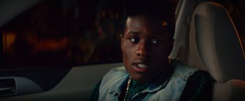 Movie still from “Dope” (2015), directed by Rick Famuyiwa – A young man sitting in front of a fire place; Close Up shot, Over the shoulder angle