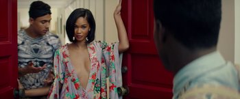 Movie still from “Dope” (2015), directed by Rick Famuyiwa – A beautiful young woman standing in front of a red door; Medium shot, Over the shoulder angle