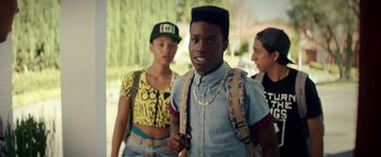 Movie still from “Dope” (2015), directed by Rick Famuyiwa – A group of young people standing next to each other; Medium shot, Over the shoulder angle